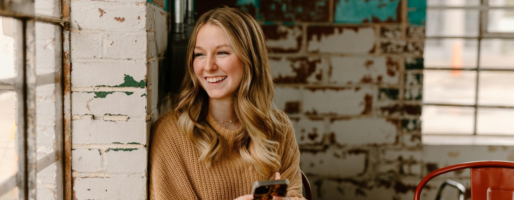 a woman sitting at a table and smiling