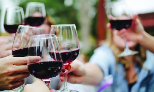 Vibrant community life with a variety of dining options people holding glasses of wine