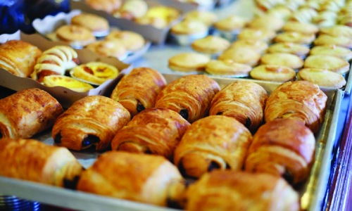 Vibrant community life with a variety of dining options trays with baked goods